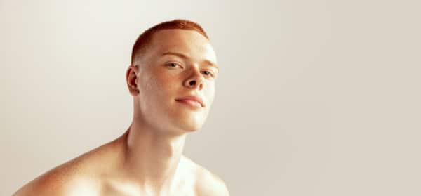 Portrait of handsome young red-haired man with freckles