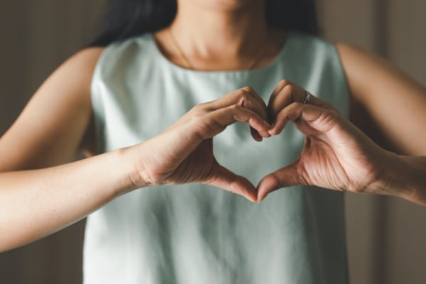 Close up of woman making heart shape for Valentines day