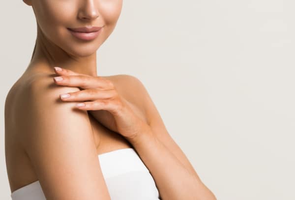 Cropped photo of a young woman with her hand on a shoulder