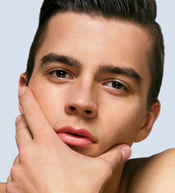 Close up portrait of a young man looking at a camera