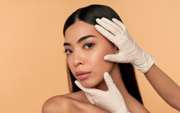 Young Asian woman with clean radiant skin gets botox injections